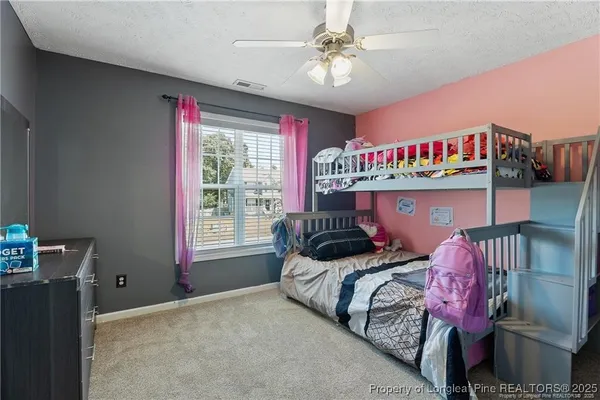 a bedroom with bed and a chandelier