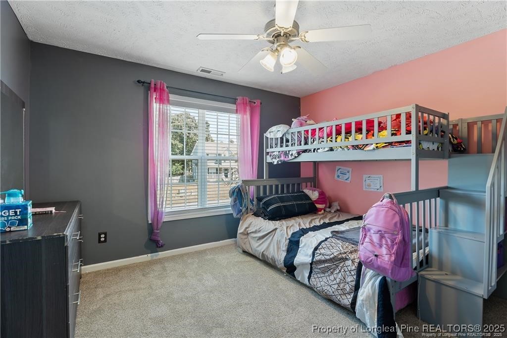 717 Lenoir Drive Spring Lake, NC 28390 - Photo 31 of 47 a bedroom with bed and a chandelier