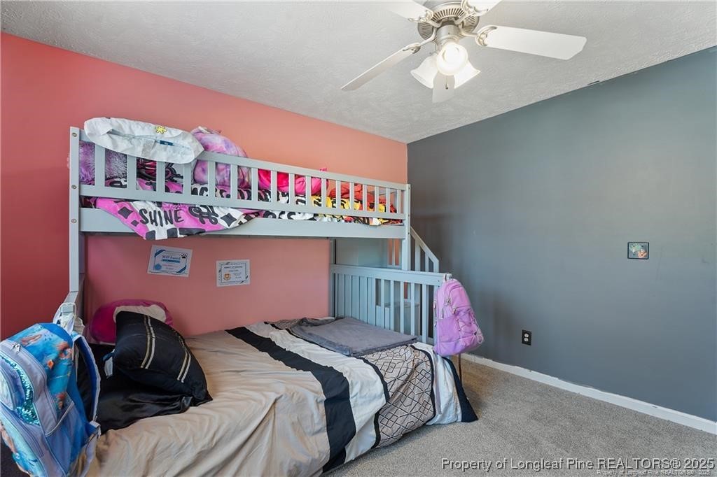 717 Lenoir Drive Spring Lake, NC 28390 - Photo 32 of 47 a bedroom with a bed and a chandelier