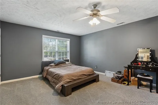 a aerial view of a house with a big yard and large trees