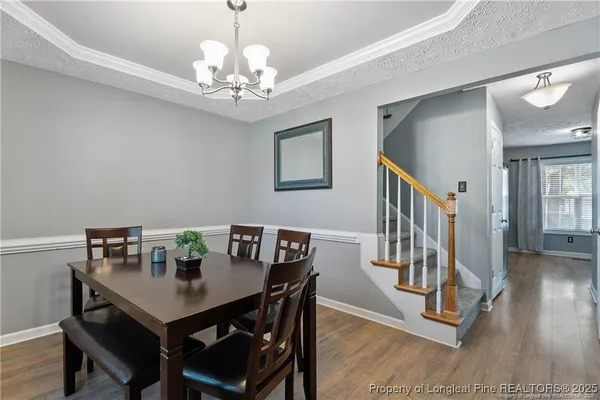 a view of a dining room with furniture and wooden floor