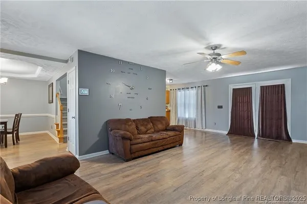 a living room with furniture and a chandelier