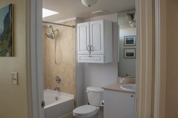 a bathroom with a sink toilet and shower
