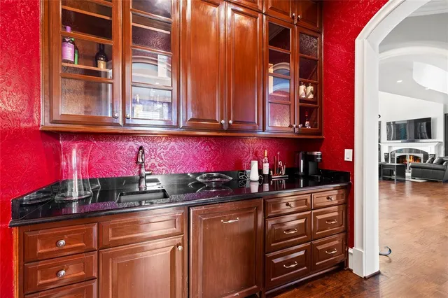 a kitchen with sink refrigerator and wooden floor