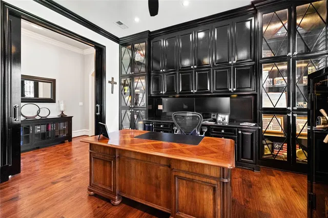 a view of a workspace with furniture and window