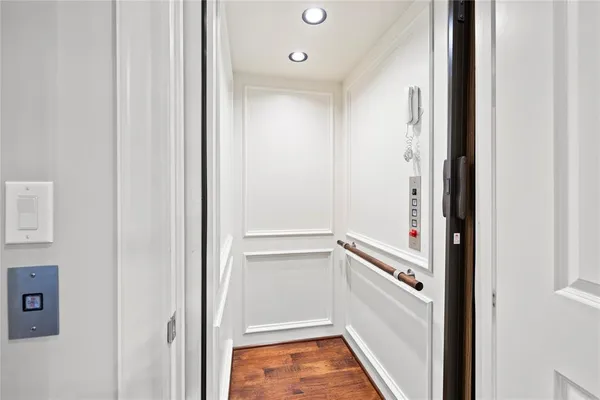 a spacious bedroom with a bed and wooden floor