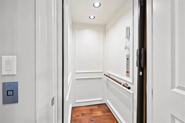 a spacious bedroom with a bed and wooden floor