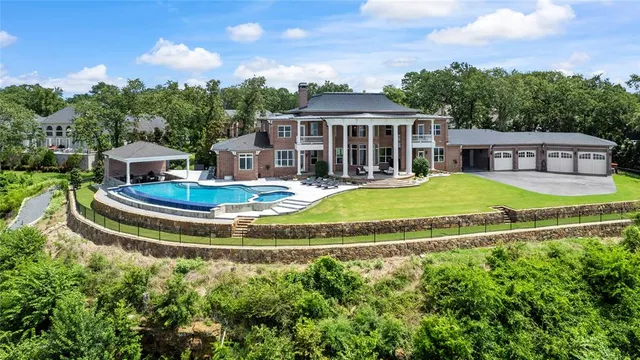 a view of a house with swimming pool and yard