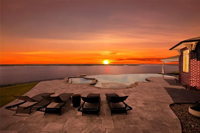 a view of a patio with table and chairs with wooden floor and fence
