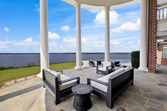 a roof deck with table and chairs