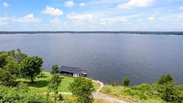 a backyard of a house with yard table and chairs