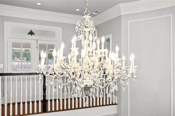 a view of entryway and hall with a chandelier