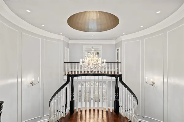 a dining room with furniture a chandelier and wooden floor