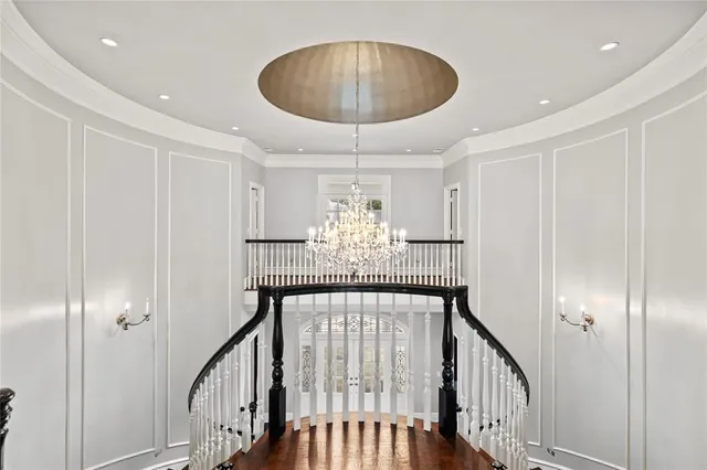a dining room with furniture a chandelier and wooden floor