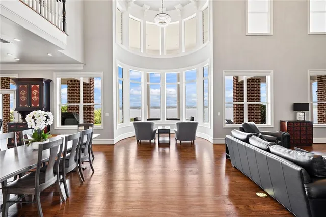 a living room with furniture and large windows