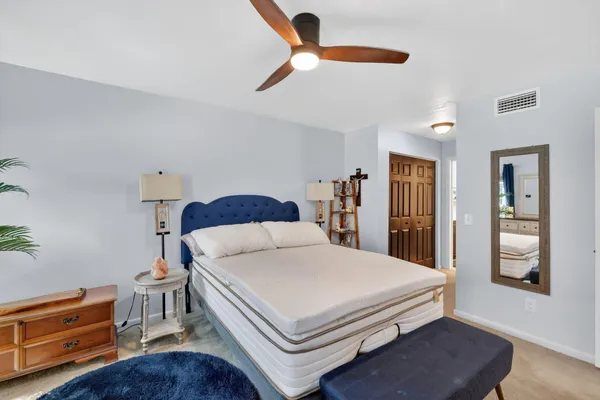 a bedroom with a bed and dresser