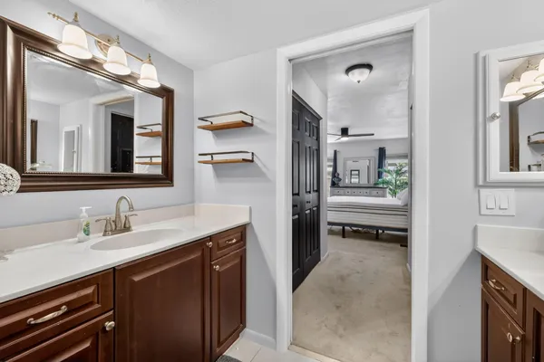 a en suite bathroom with a sink and a mirror