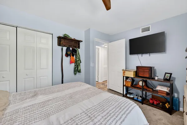 a bedroom with a bed and a flat screen tv