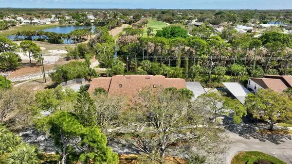 an aerial view of residential house with an outdoor space and seating