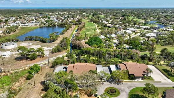 an aerial view of residential houses with outdoor space