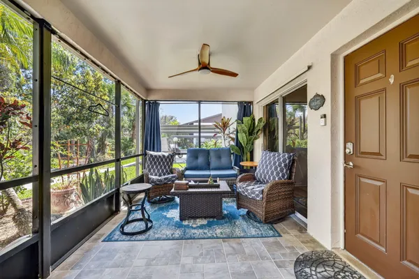 a living room with furniture and a floor to ceiling window