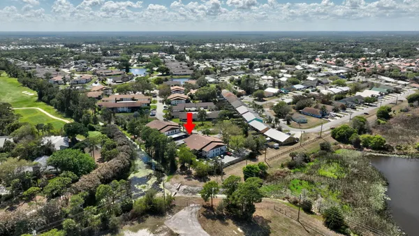 an aerial view of residential building with green space