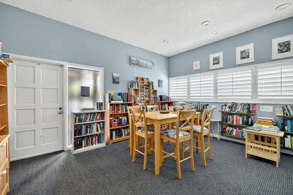 a room with furniture pool table and windows