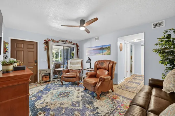 a living room with furniture rug and a window