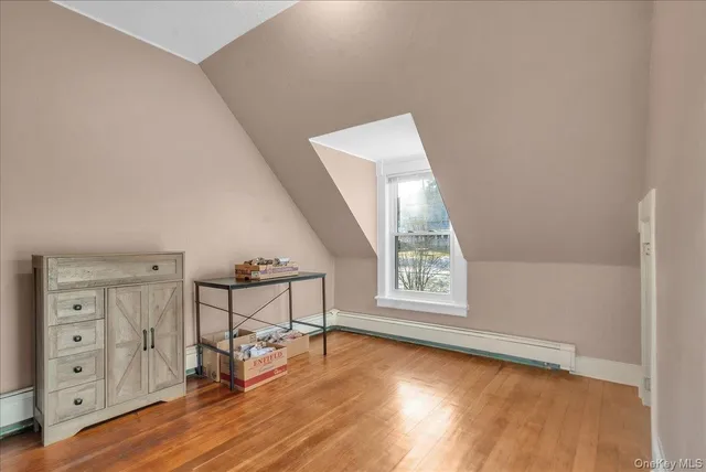 an empty room with windows and wooden floor