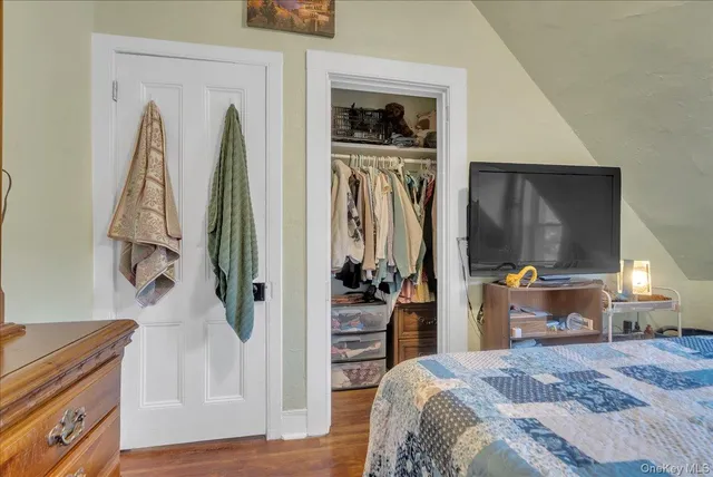 a bedroom with a bed and a television