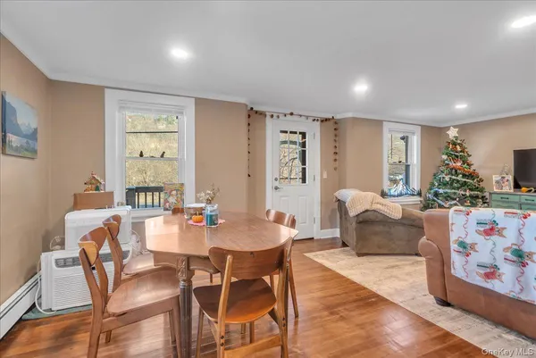 a view of a dining room with furniture window and wooden floor