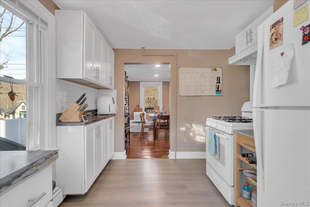 10 Spartan Place, Unit B Tuxedo Park, NY 10987 - Photo 5 of 27 a kitchen with stainless steel appliances granite countertop a refrigerator and a stove top oven