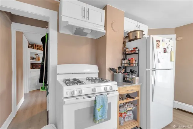 a kitchen with a stove and a refrigerator