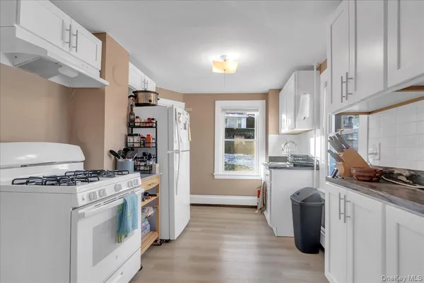 a kitchen with stainless steel appliances a stove a sink and a refrigerator