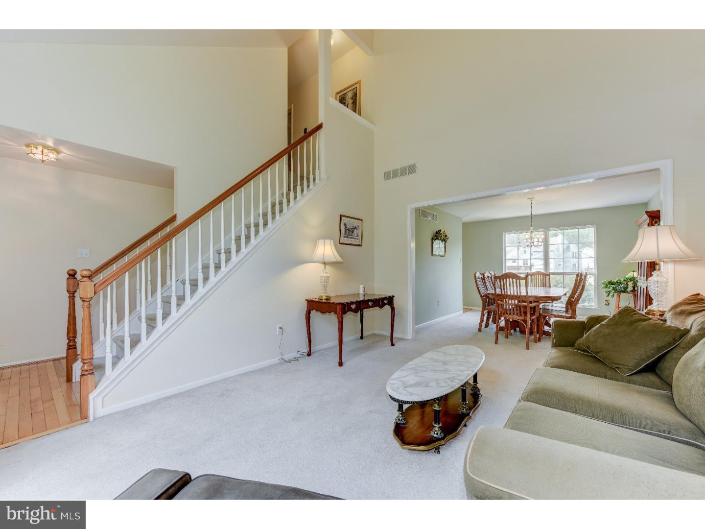 652 Melvin Road Telford, PA 18969 - Photo 11 of 25 a living room with couches and a dining table with wooden floor