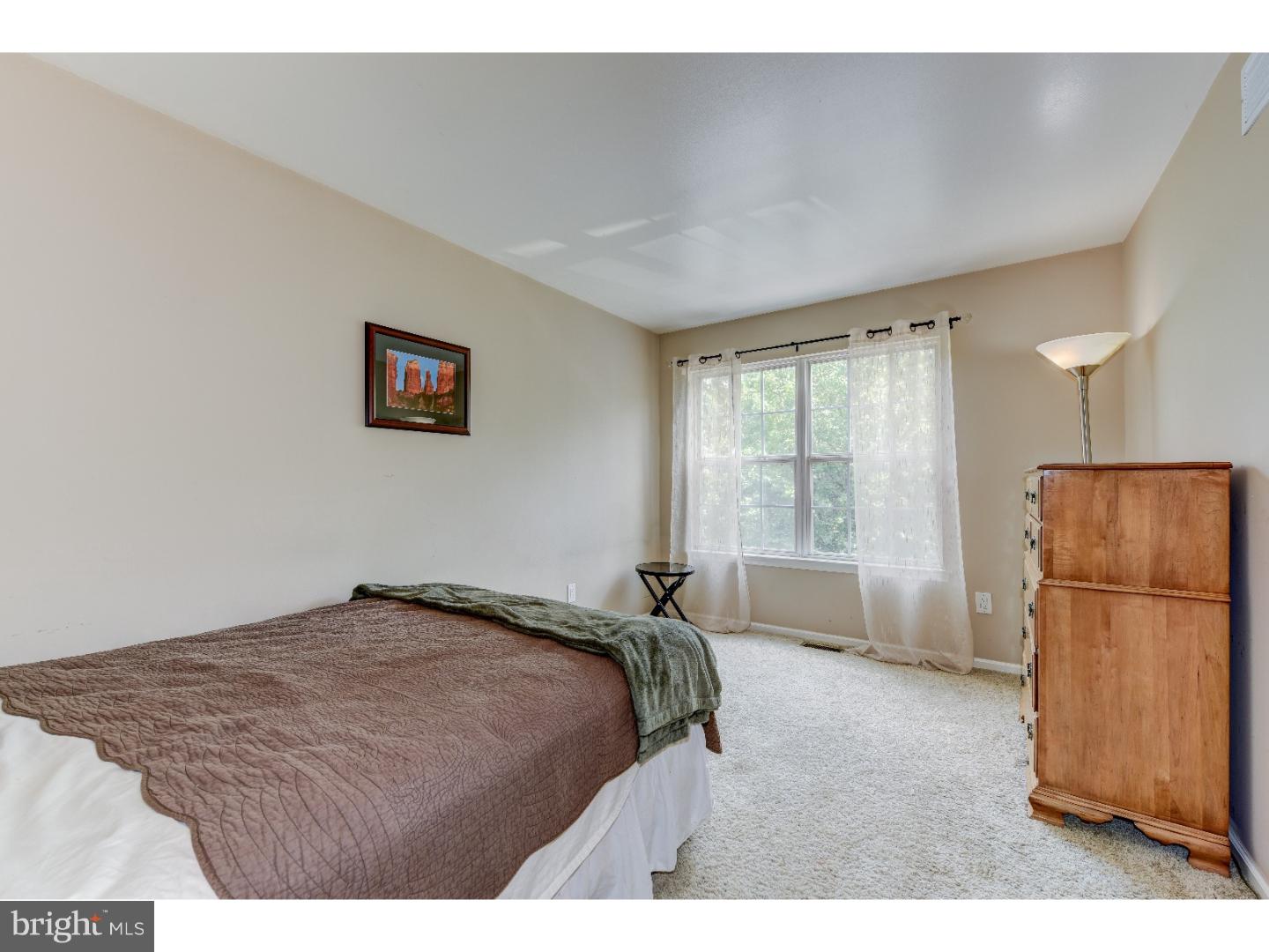 652 Melvin Road Telford, PA 18969 - Photo 18 of 25 a bedroom with a bed and a refrigerator