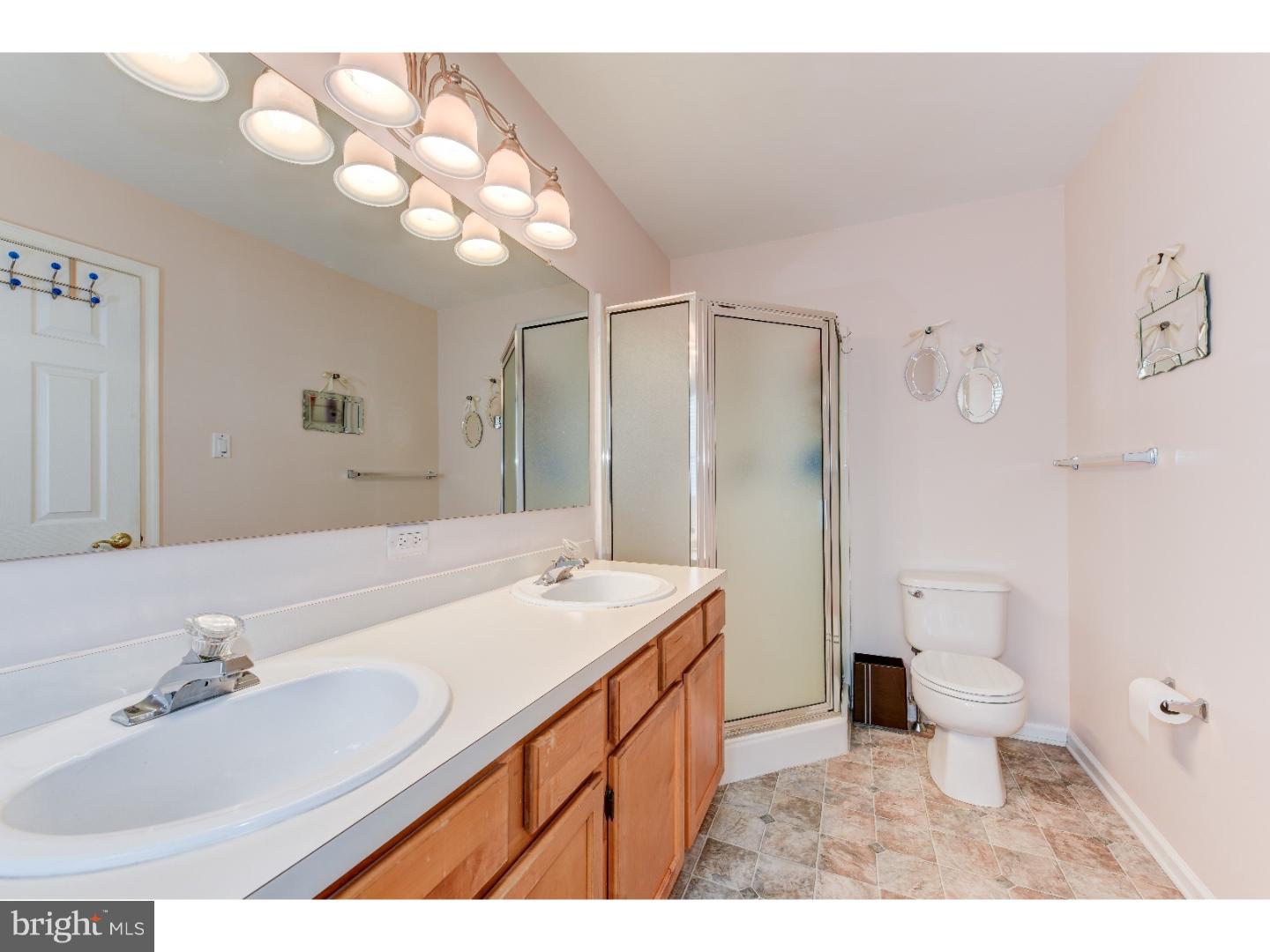 652 Melvin Road Telford, PA 18969 - Photo 20 of 25 a bathroom with a sink a toilet a large mirror and shower
