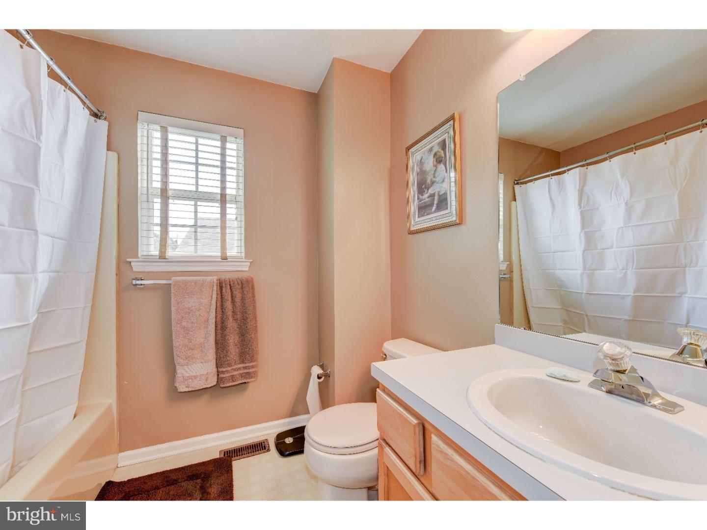 652 Melvin Road Telford, PA 18969 - Photo 21 of 25 a bathroom with a sink a toilet and a mirror