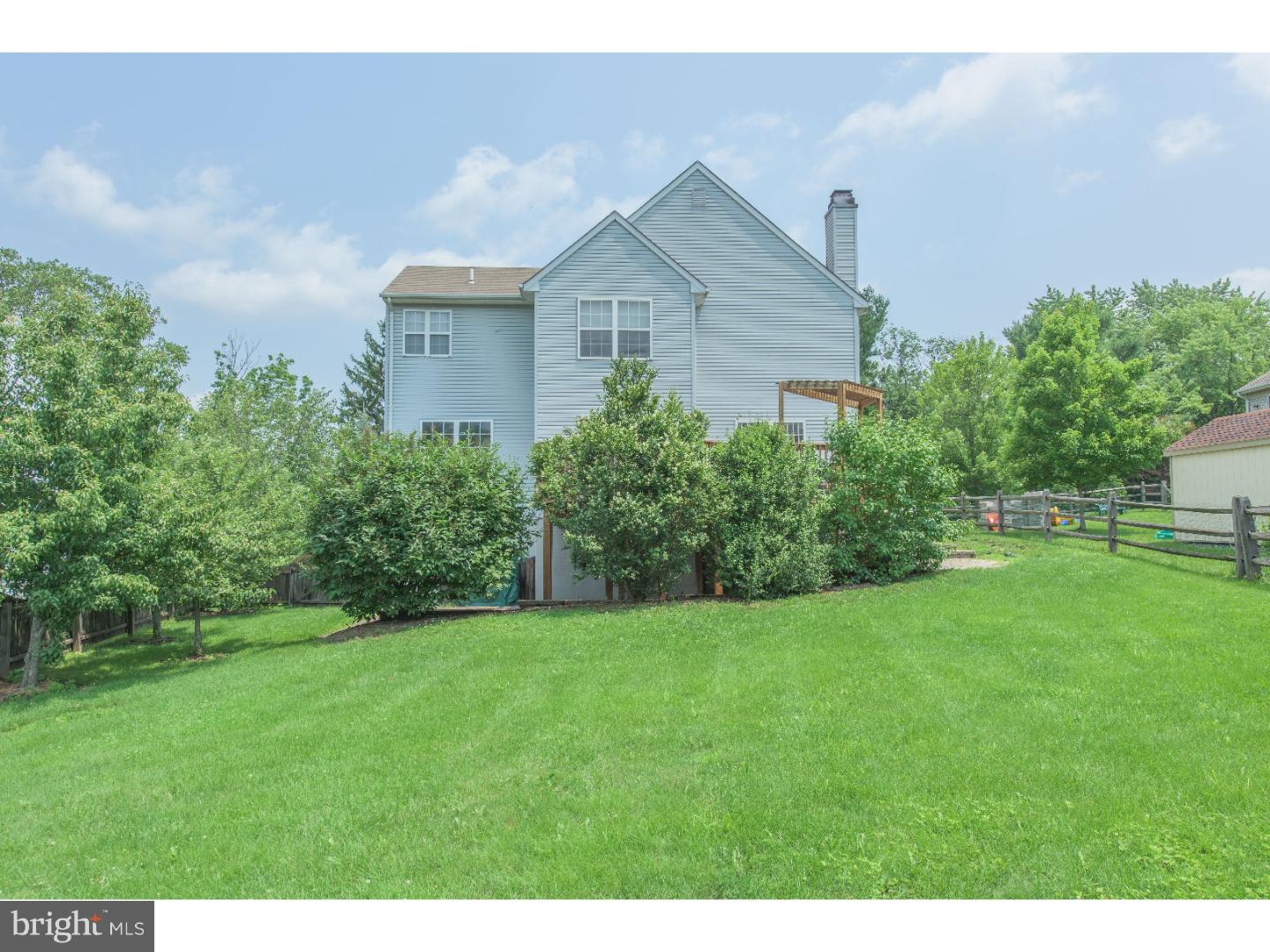 652 Melvin Road Telford, PA 18969 - Photo 24 of 25 a view of a house with a big yard potted plants and a large tree