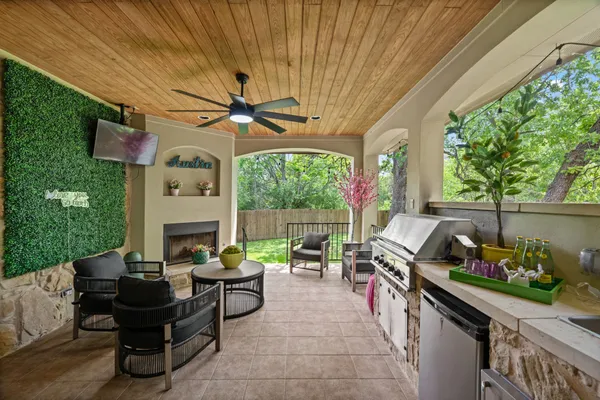 a living room with patio furniture and a fireplace