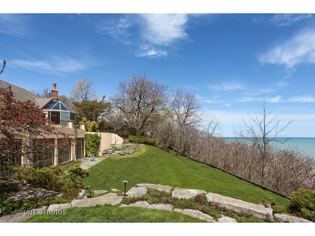 1203 Whitebridge Hill Road Winnetka, IL 60093 - Photo 2 of 24 a front view of a house with a yard