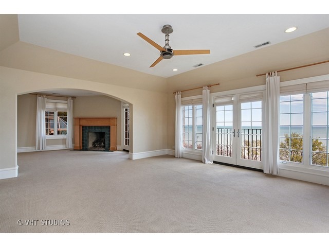 1203 Whitebridge Hill Road Winnetka, IL 60093 - Photo 11 of 24 a view of an empty room with a fireplace and a window
