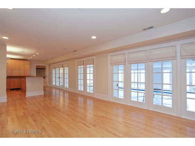 1203 Whitebridge Hill Road Winnetka, IL 60093 - Photo 14 of 24 a view of an empty room with wooden floor and a window