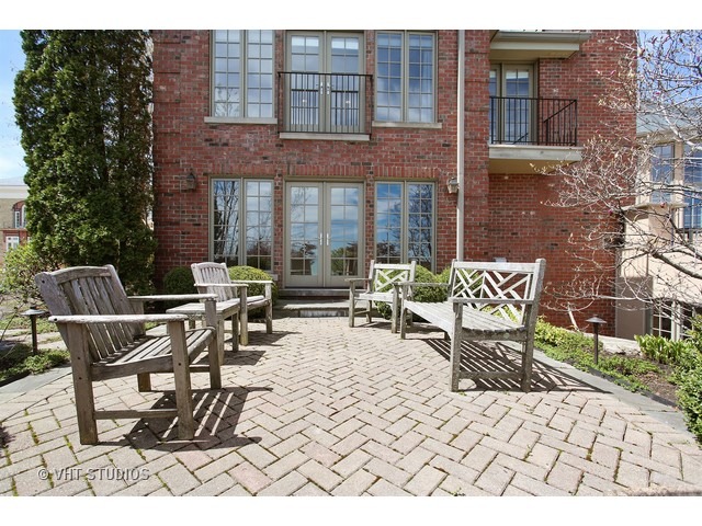 1203 Whitebridge Hill Road Winnetka, IL 60093 - Photo 20 of 24 a view of a patio with a table and chairs
