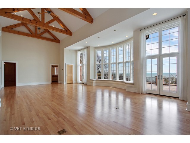 1203 Whitebridge Hill Road Winnetka, IL 60093 - Photo 5 of 24 a view of an empty room with wooden floor and a window