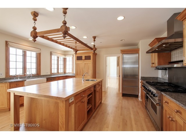 1203 Whitebridge Hill Road Winnetka, IL 60093 - Photo 6 of 24 a kitchen with stainless steel appliances granite countertop a sink a stove and a refrigerator