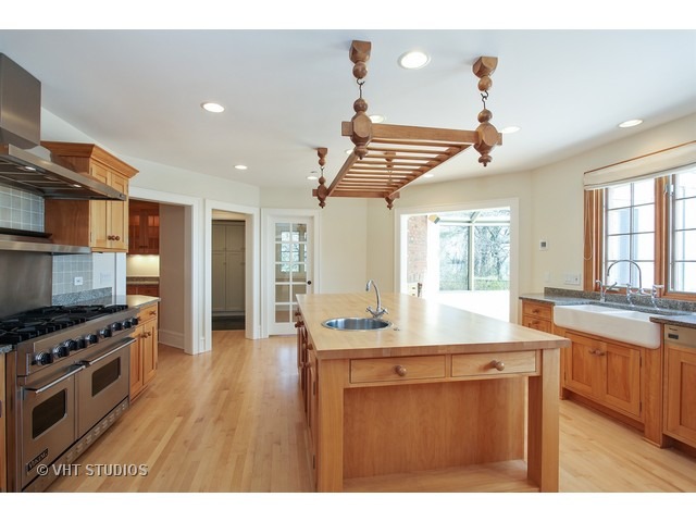 1203 Whitebridge Hill Road Winnetka, IL 60093 - Photo 8 of 24 a kitchen with stainless steel appliances granite countertop a sink and a stove