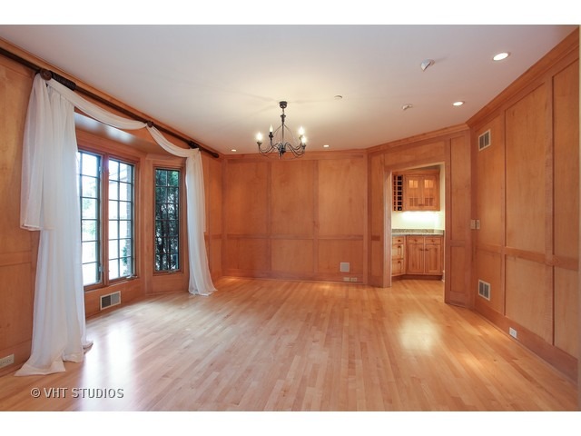 1203 Whitebridge Hill Road Winnetka, IL 60093 - Photo 9 of 24 a view of an empty room with window and wooden floor