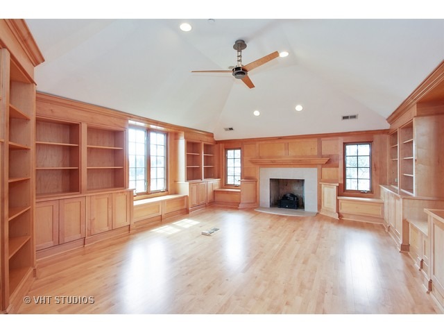1203 Whitebridge Hill Road Winnetka, IL 60093 - Photo 10 of 24 a view of an empty room with wooden floor fireplace and a window