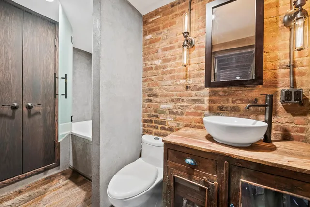 a bathroom with a toilet a sink and shower